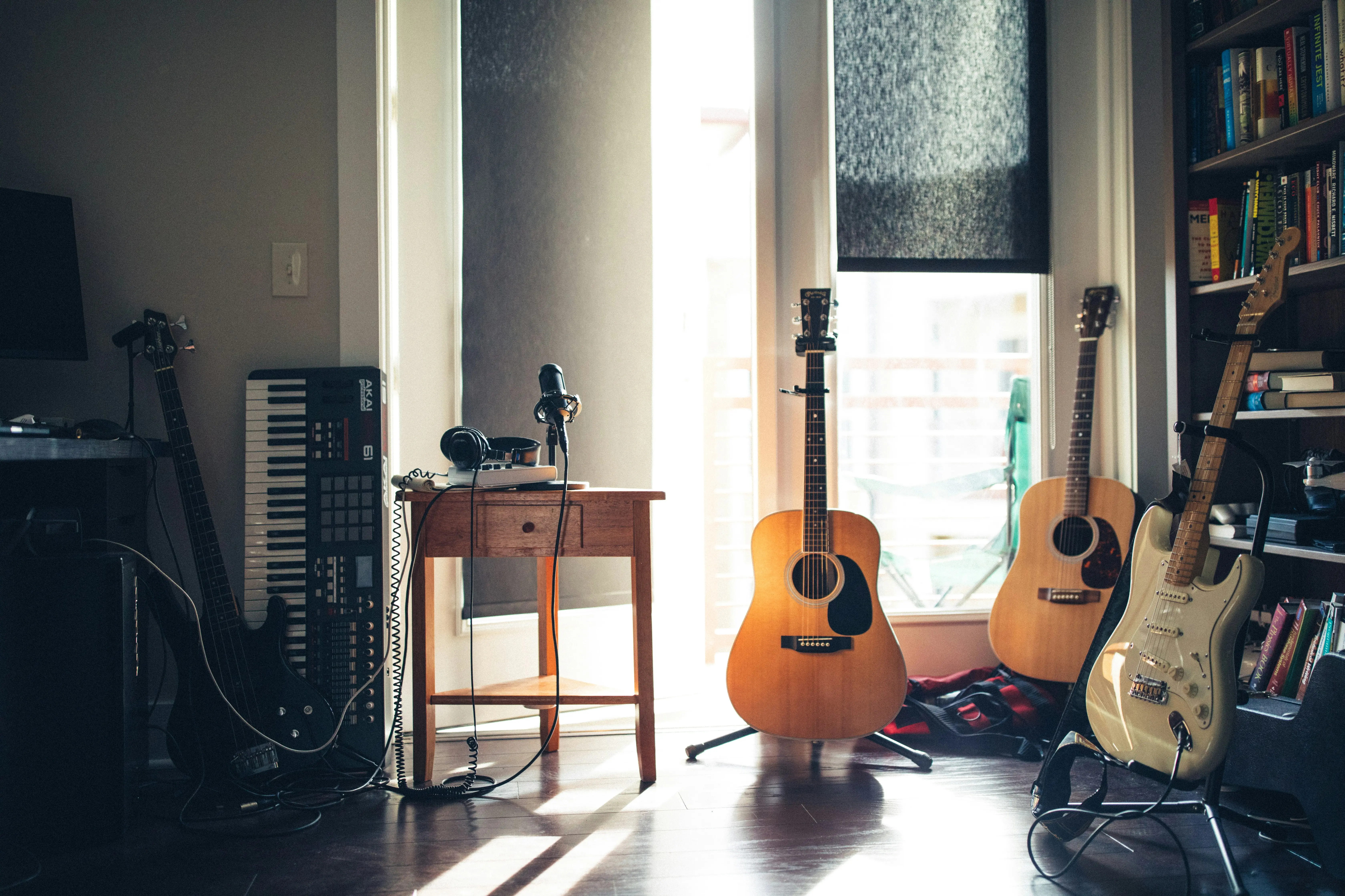Guitarist in soft window light, working through songs